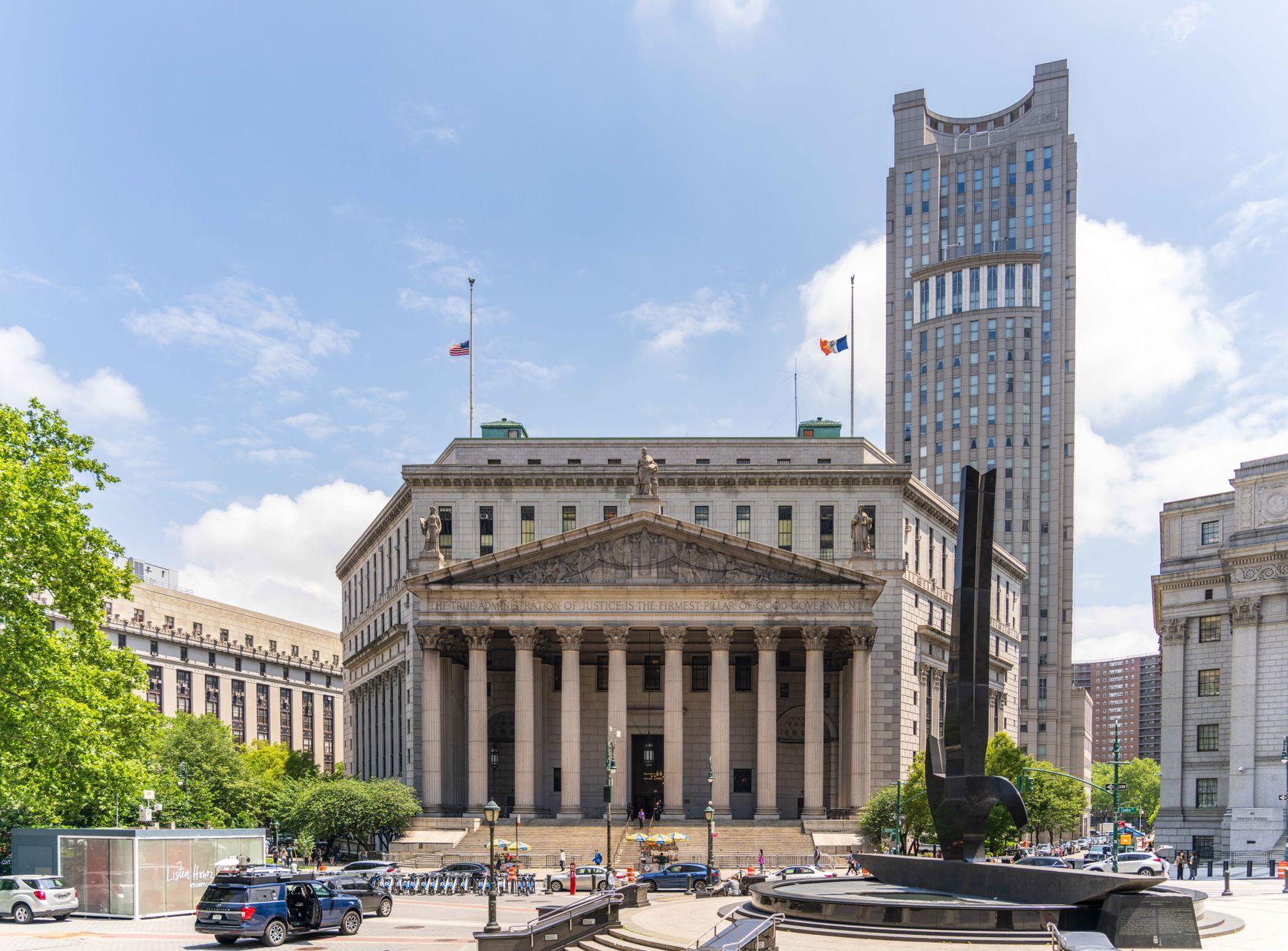 View of the historic New York County Courthouse with clear skies and cityscape.