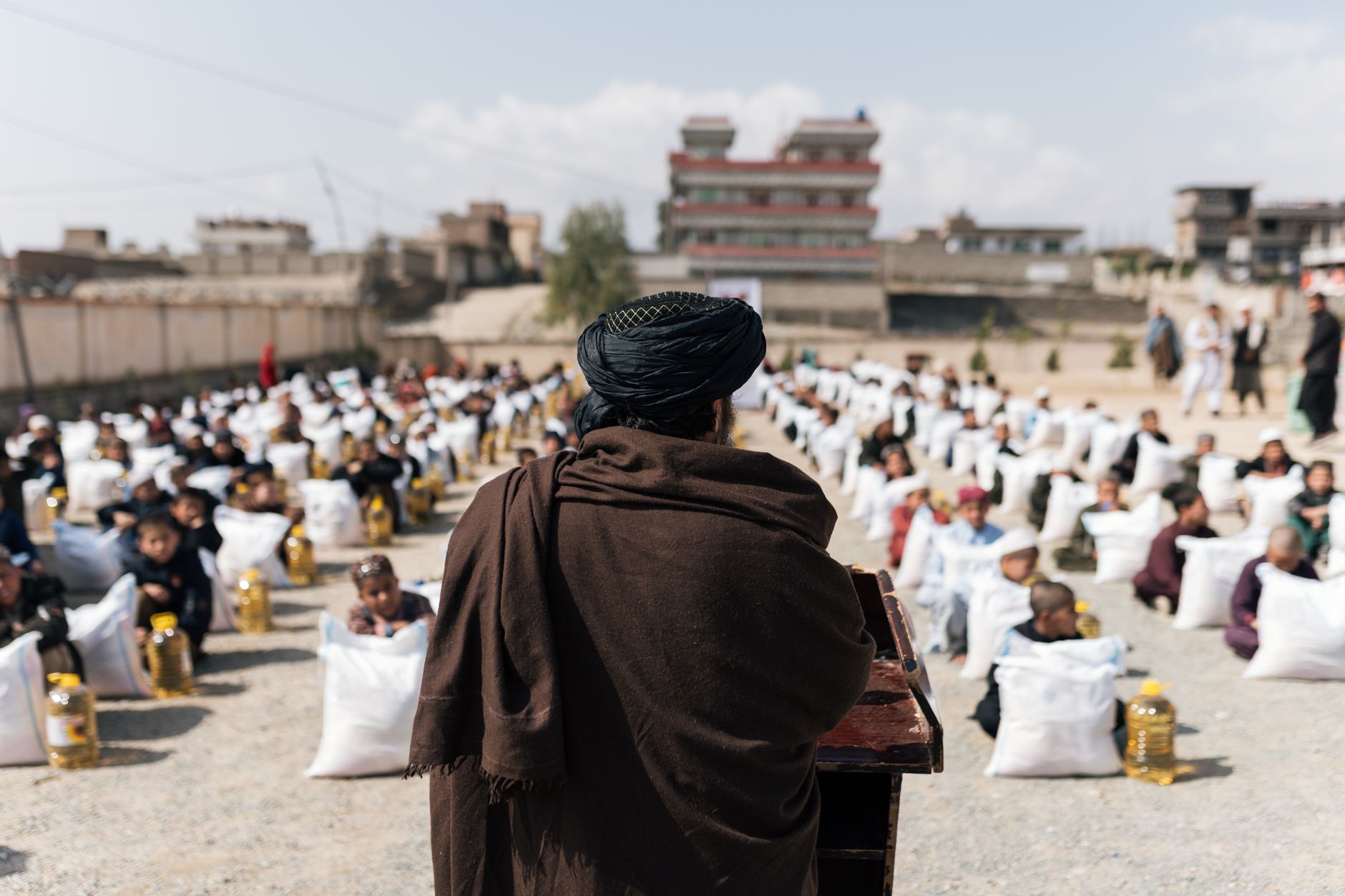Crowd gathered for a humanitarian aid distribution event in Afghanistan.